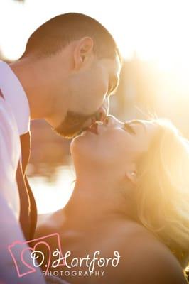 Couple shares a romantic sunset kiss. Couples Photography