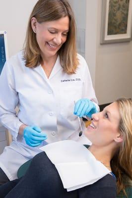 Dr. Cox performing a teeth cleaning