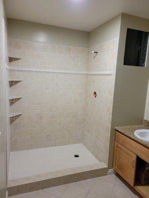 Installed Shower Tile and Shelves. Built-in Cabinet Nook. New Paint on Bathroom Walls, Ceiling, and Baseboards.