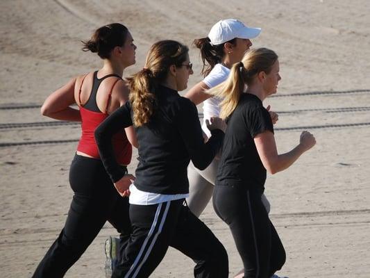 Women at Adventure Boot Camp in Santa Monica/Pacific Palisades getting in some cardio at the beach.