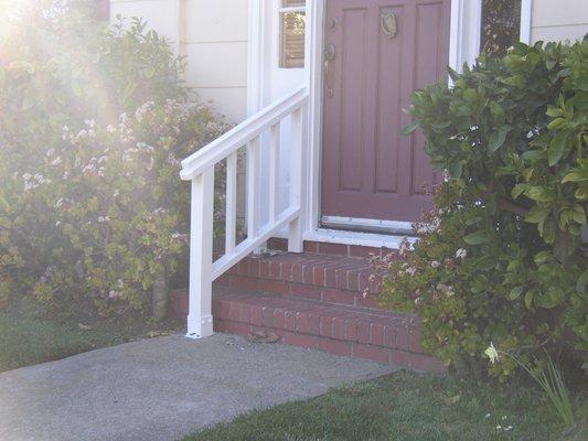 Custom built wood hand rail made to blend in with architecture of house.