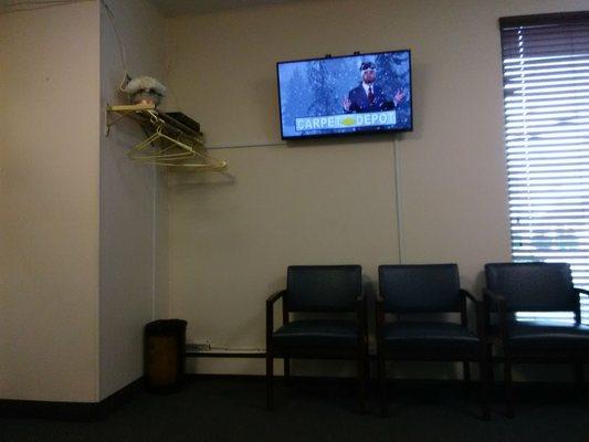 Comfortable chairs and TV in waiting room.