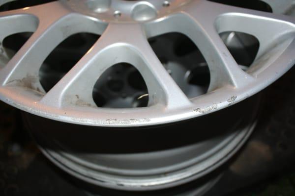 This was my wheel before they worked on it - notice the curb rash and scratches.  Then look at my after photo closeup pix