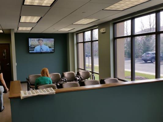 large well lit waiting area with 50" television