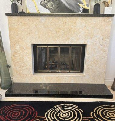 Ubatuba black and cream granite fireplace.