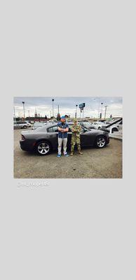 Gregg cooper and a soldier with his first car.