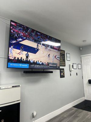 TV showing sports throughout haircut sessions.