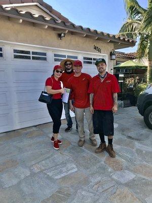 Happy team after finishing 26 panels on a tile roof in Westminster .