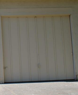 BEFORE  heavy wooden garage doors, ugly and drafty.