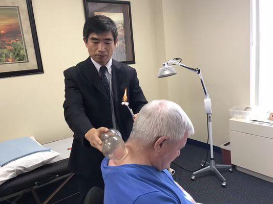 Dr. Lu is treating the patient with cupping.