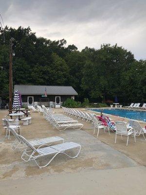 Pool deck and tiki hut in the distance