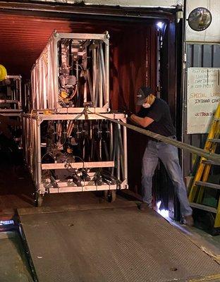 Shockwave Cargo onsite operations team loading ocean containers with Truss/Lighting/Video for Concert tours and Broadway shows.