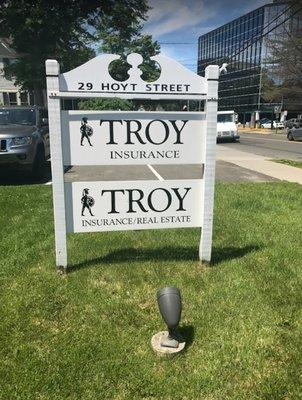 Outside front sign of the Troy Insurance office.