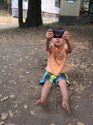 Playing in dirt in front of the cabin