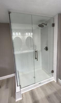 Custom shower glass with notch panel and back to back ladder pull