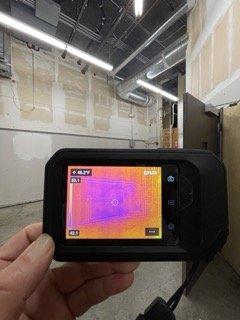 An infrared camera is displaying drywall that has been affected.