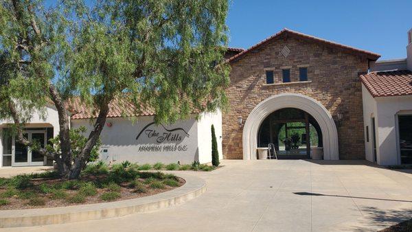 The grill is inside the arched doorway to the left