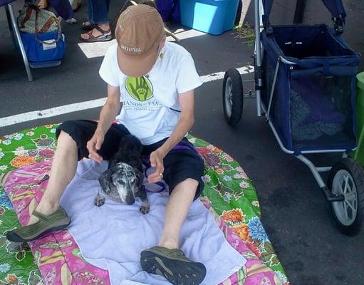 Otis getting a massage at Morgan Street Fair