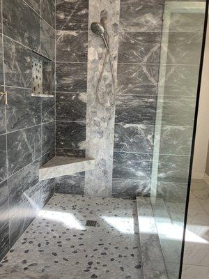 12x24 marble stone 
Horizontal layout
Vertical decorative band 
Stone floor
Doorless shower