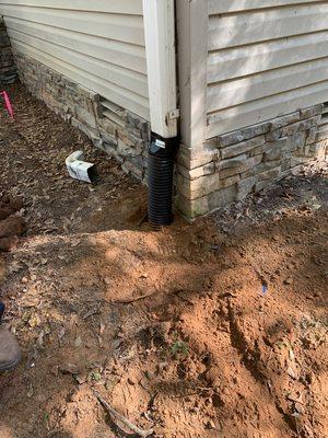 Downspouts connected with 4" solid drain tile take roof water away from the foundation.