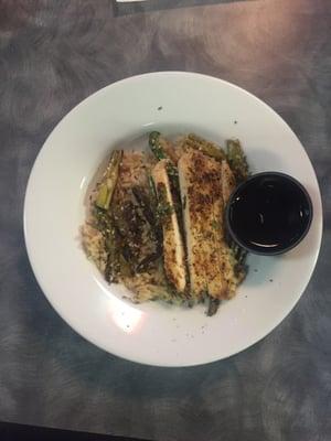 The Yaki Chicken Bowl served with brown rice, some sesame seeds, grilled asparagus, teriyaki sauce.