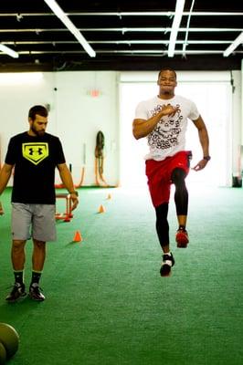 FT Trainer Louis Rojas works with an NFL athlete.