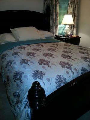 a cozy custom made duvet cover with matching drapery panels, and roman shades are a must!