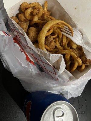 Popcorn chicken with curly fries and Pepsi can