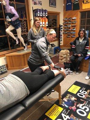 Elliott Physical therapists Jackie and Kelsey demonstrate dry needling at Marathon Sports.