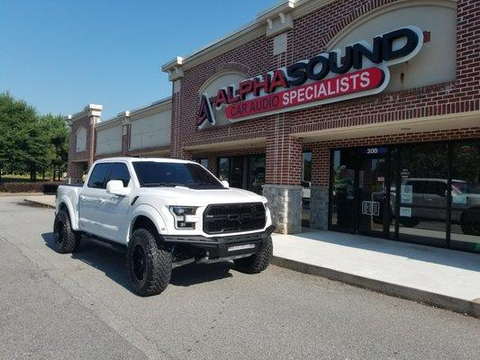 Ford raptor with Fab Fours bumpers, Rigid light bar, and body color painted fenders, mirrors and door handles.