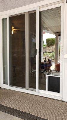 Pet door installed into dual pane sliding glass door.