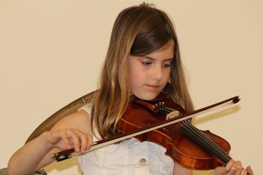 Violin student performs at recital.