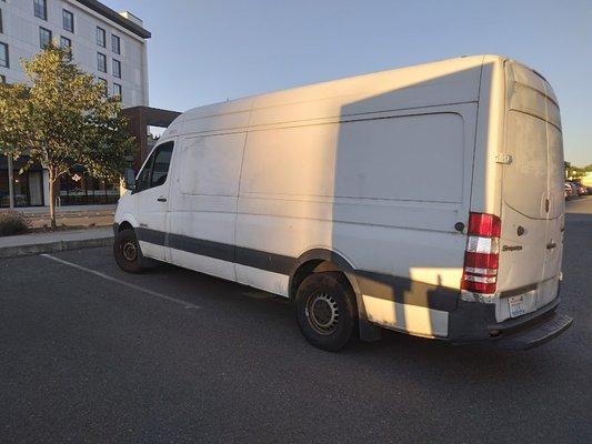 Van clearly blocking the way for cars in front parking lot