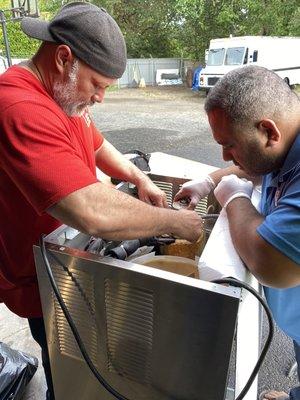 Ite & Semu repairing an ice machine for a customer