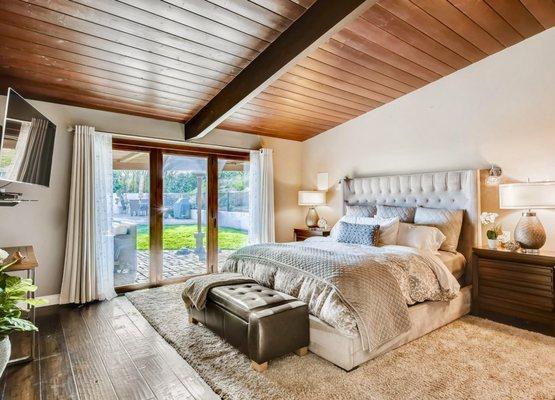 Luxury master bedroom. Beamed ceilings and hard wood throughout!