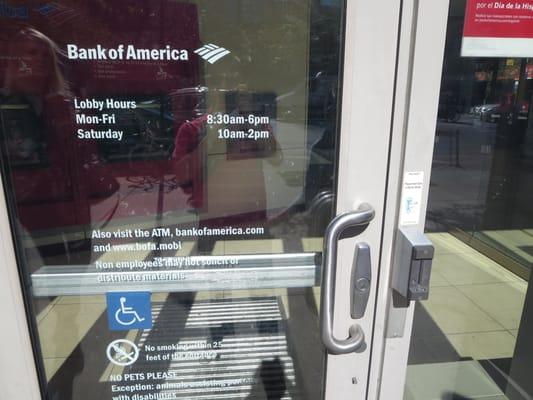 Entrance to ATM area. You must swipe your Bank of America card to gain entry. Business hours are posted on the door.