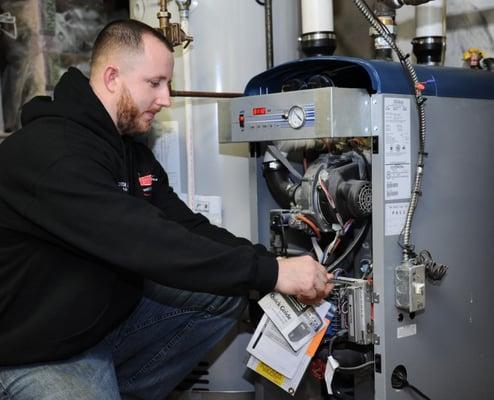 Luke inspecting a unit for repair, we value quality service so you get the life you should out of your product!