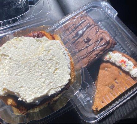 cinnamon bun, chocolate brownie and a slice of cookie cake