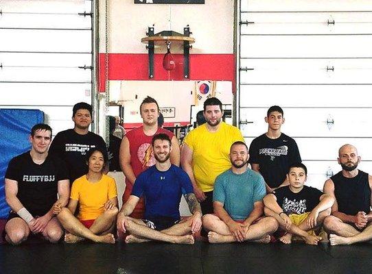 Picture taken after BJJ NoGi Submission/Grappling class. Coach Neil Johnson in light blue, and Coach Kenny Geadreau in dark blue.(first row)