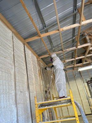 Spraying Closed-Cell Spray Foam Insulation in  a metal building.