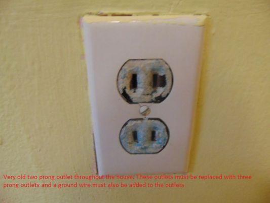 Two prong outlet and should be three prong. Two prong outlets have no ground