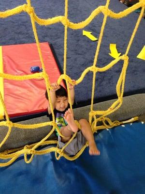 Loves climbing the rope wall