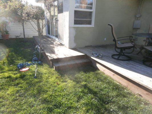 Back yard deck with small step down to lawn.