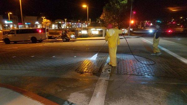 Pressure washing of entrance pavers at a commercial shopping center.