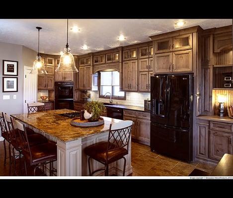 The cabinetry in this kitchen uses Rustic Alder in the Arlington door style with Rockport finish and Gray Wash.