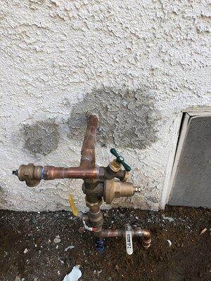 New water main riser and stucco patching after full house repipe.