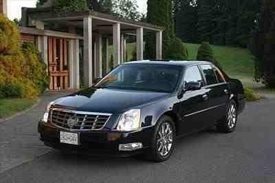 Cadillac DTS black 3 passenger capacity