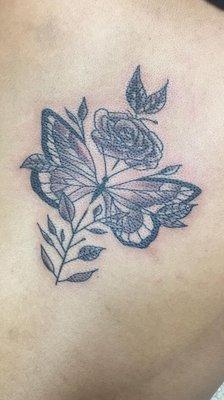 Butterfly & flower tattoo done by artist Erica Rivera