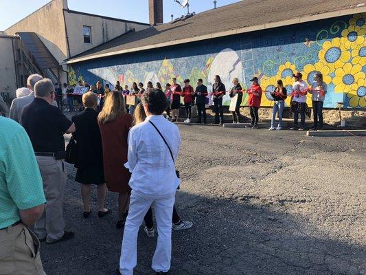 Wall mural ribbon cutting.