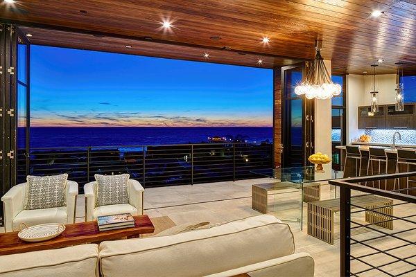 The large folding wall opens up the home to the large balcony and amazing ocean view.